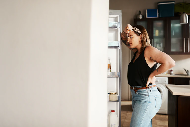 Woman staring at fridge