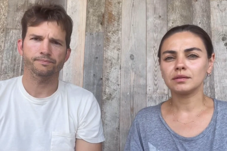 A photo of a man and woman speaking into a camera.
