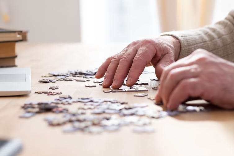 Older man doing a jigsaw puzzle