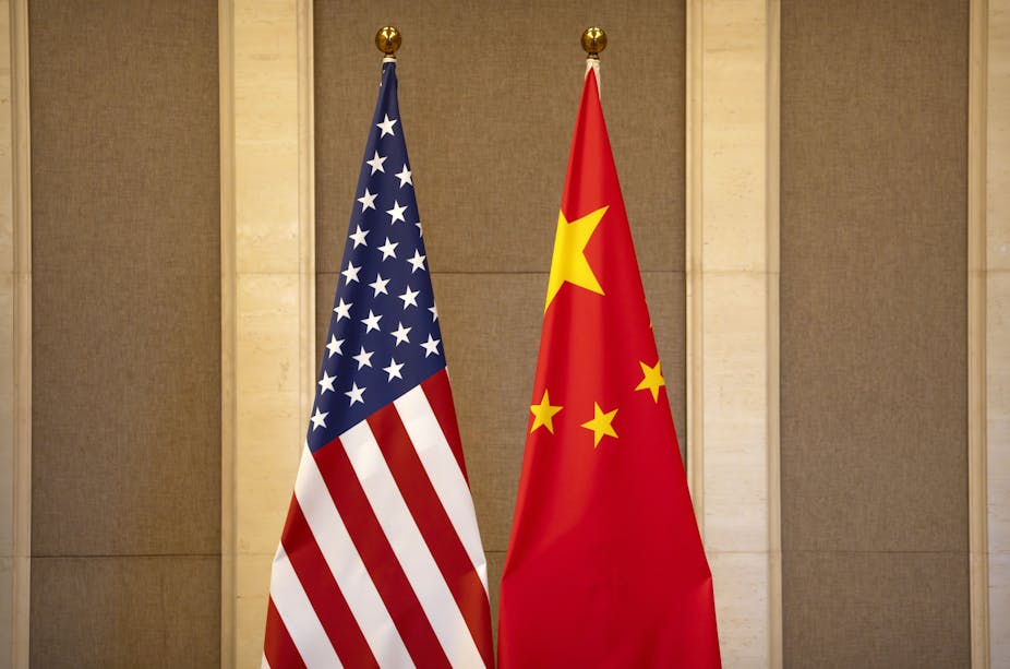 United States and Chinese flags are set up before a July 8, 2023 meeting between U.S. and ChThe American and Chinese flags stand side by side.