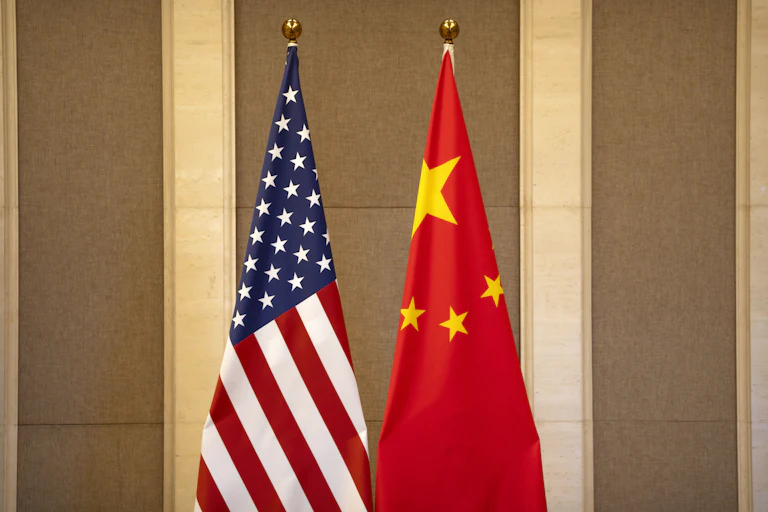 United States and Chinese flags are set up before a July 8, 2023 meeting between U.S. and ChThe American and Chinese flags stand side by side.