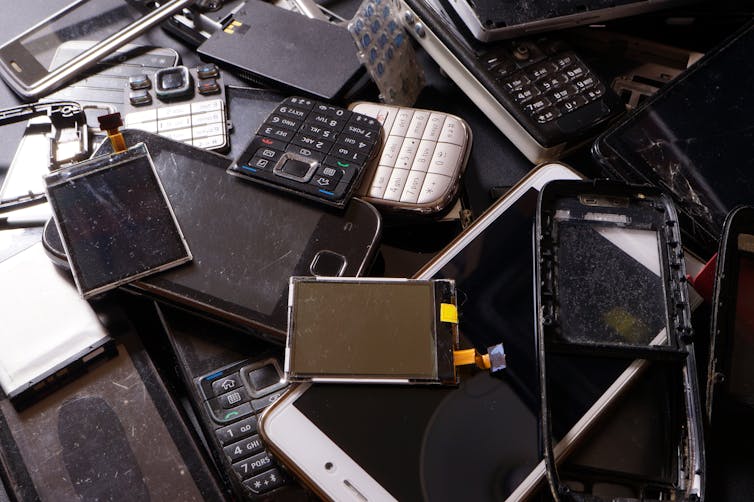 A pile of broken mobile phones