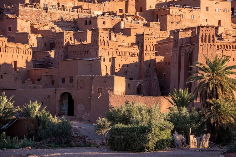 A wide shot of historic clay buildings in Morocco.