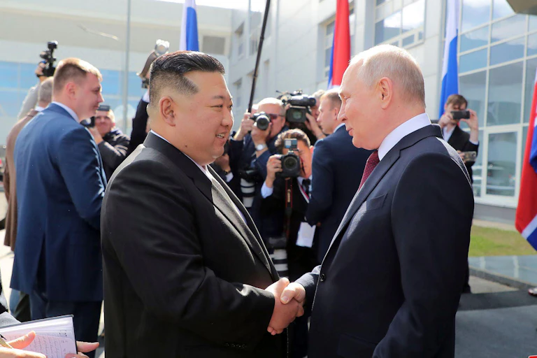 Russian president Vladimir Putin shakes hands with North Korean leader Kim Jong-Un.