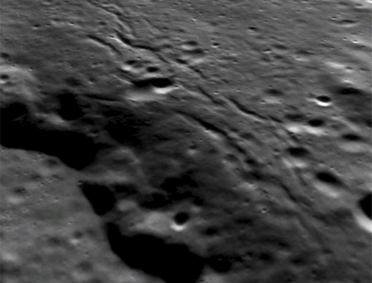 Lobate scarp, with visible grabens on its crest.