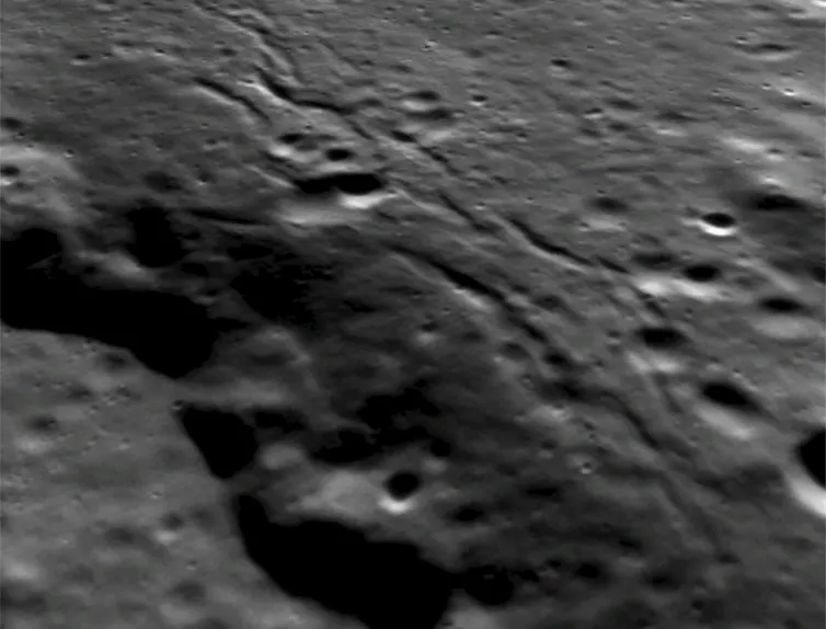 Lobate scarp, with visible grabens on its crest.