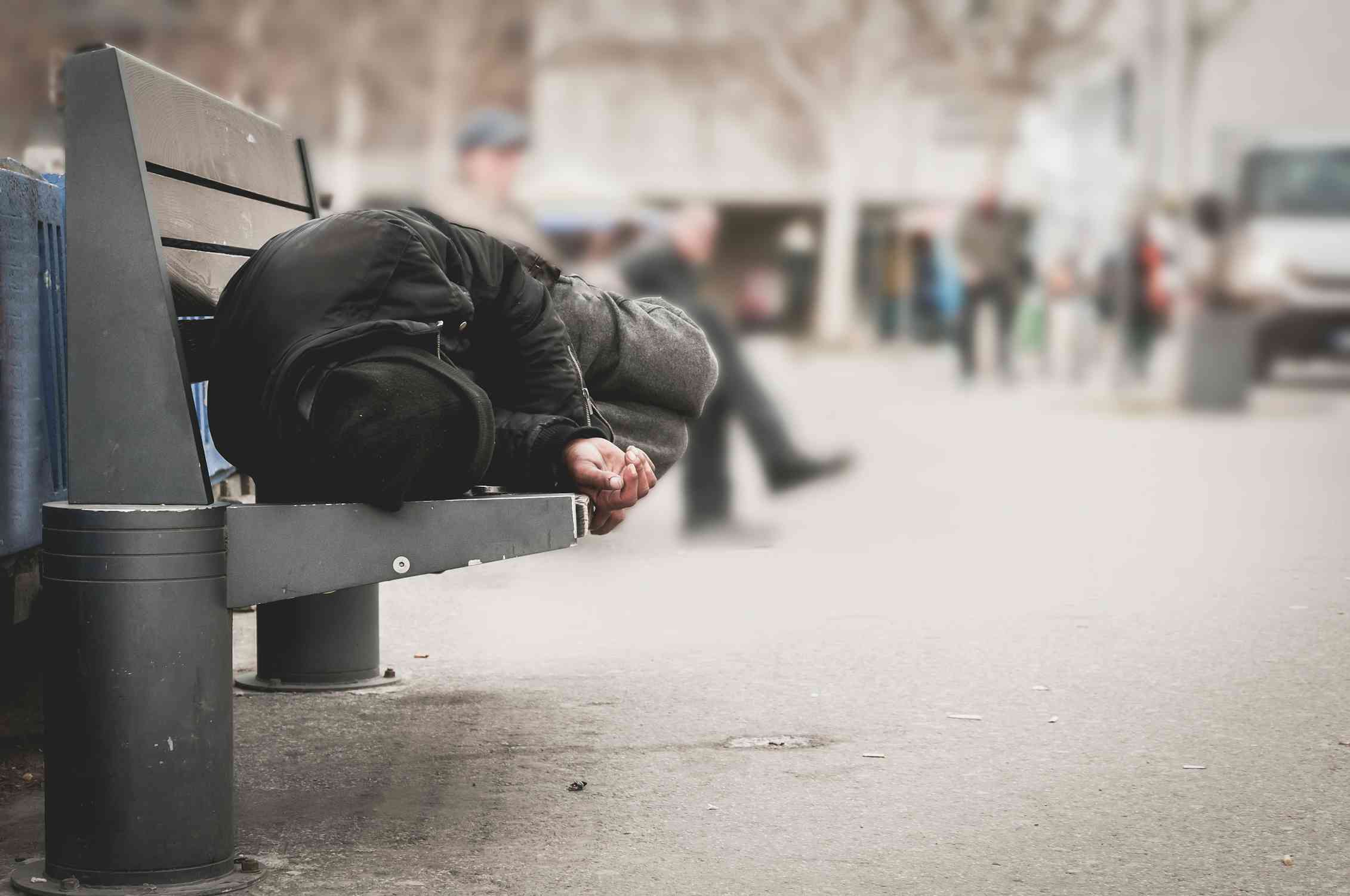 A man lying on a bench