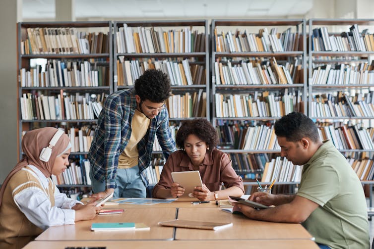 A group of students studying together in the library.