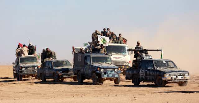Militants in cars crossing the desert. 