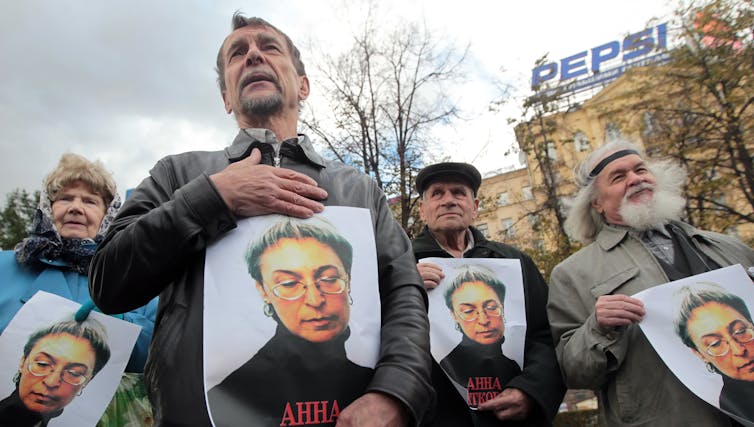 People carrying pictures of murdered journalist Anna Politkovskaya