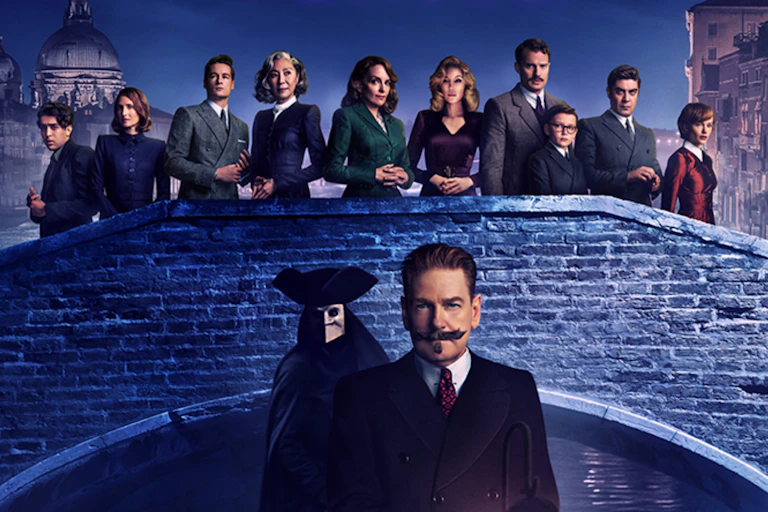 Poirot in a gondola in Venice with the cast looking on from a bridge.