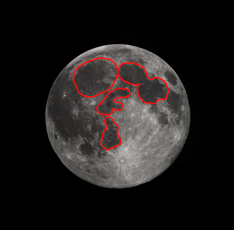 The Moon, with the dark regions outlined in red, showing a face with two ovals for eyes and two shapes for the nose and mouth.