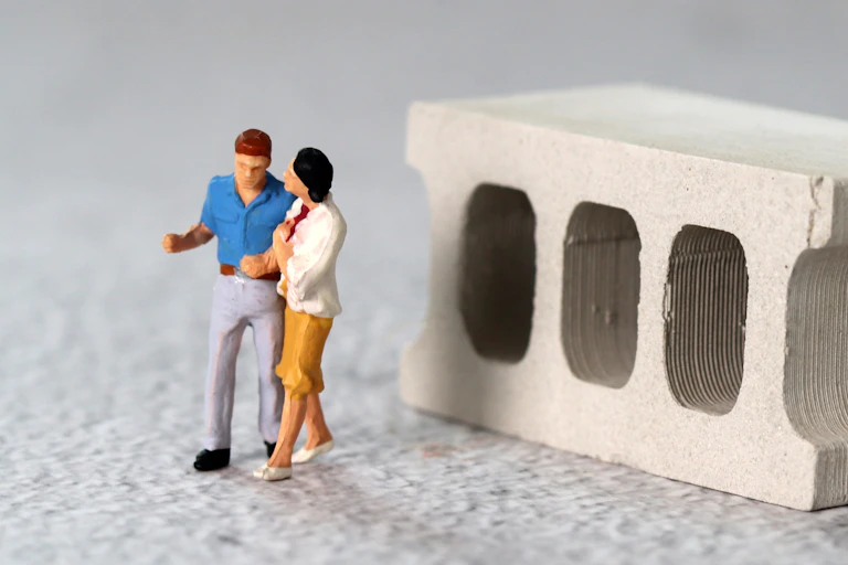 Two miniature couples facing in opposite directions. One is young, the other old.