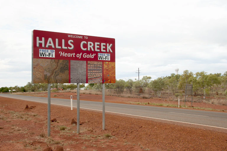 A street sign displays the words Halls Creek, which is a remote community in the Kimberley.
