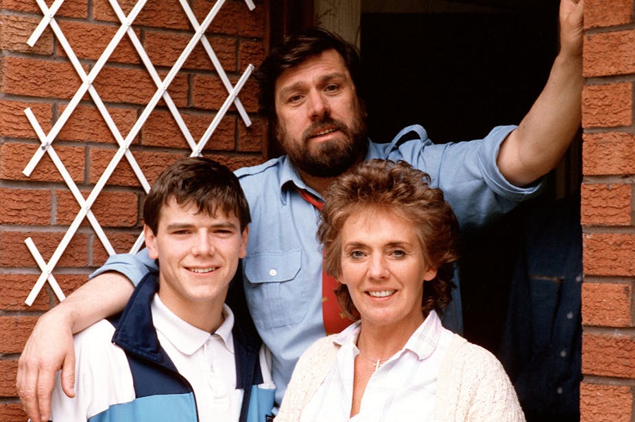 A photo of a fictional family from soap opera Brookside standing on the threshold of their home. 
