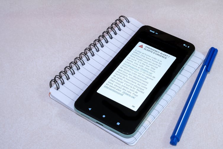 A phone displaying an emergency alert message