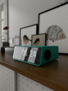 An alarm clock on a shelf.