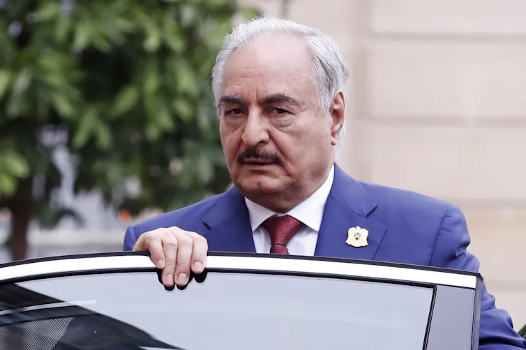 Libyan warlord Khalifa Haftar gets into a car.
