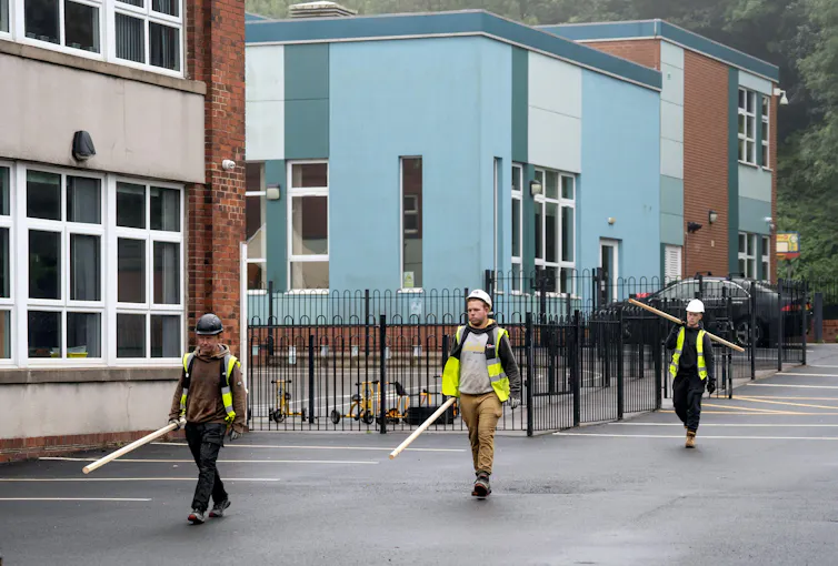 Construction workers outside school