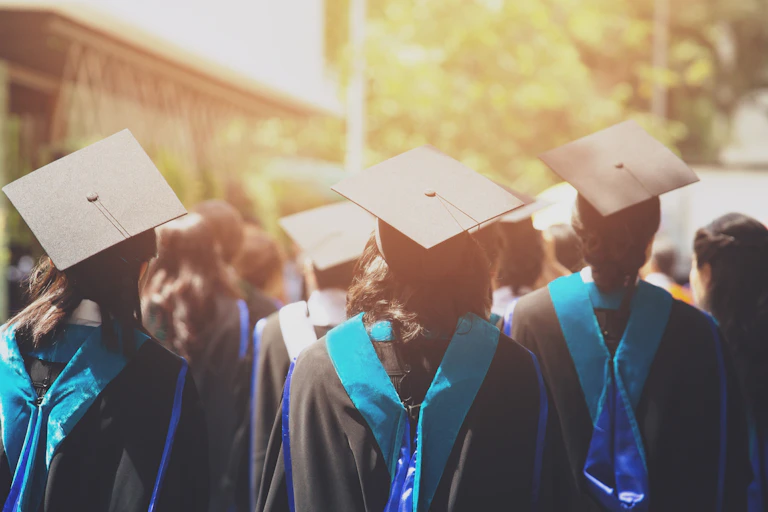 Students in mortarboards facing away from camera