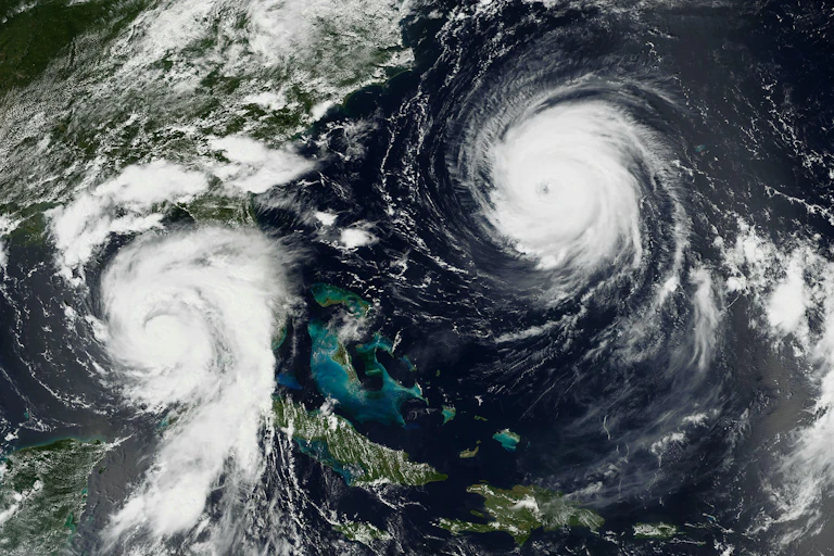 Two hurricanes. Franklin, more powerful at that point, has a clear eye wall.