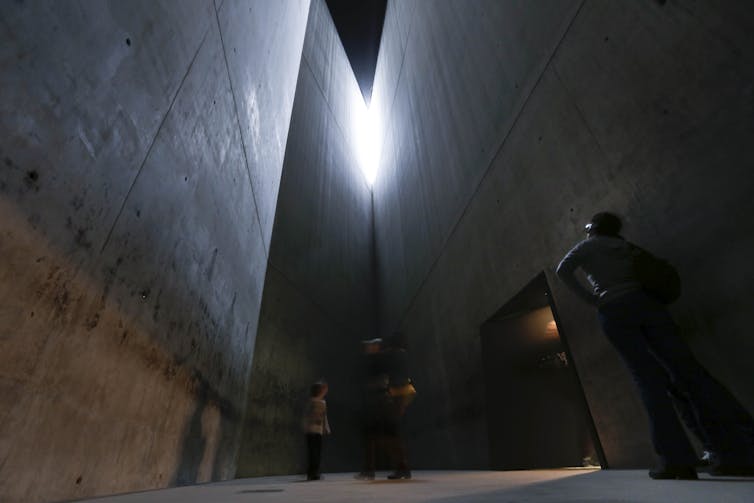 A concrete structure; a small light from above.