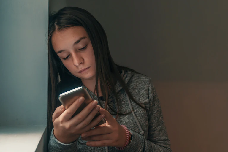Girl looks at phone