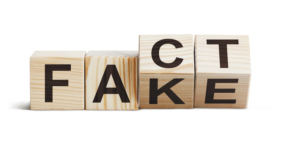 Four wooden blocks spell the words "Fake" and "Fact" as they turn. 