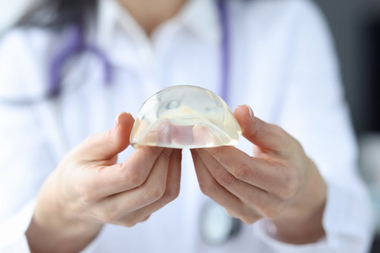 Clinician holding a silicone breast implant