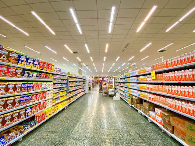 A grocery store aisle with rows of UPF products on display.