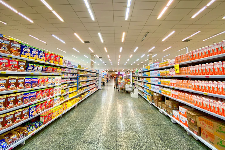A grocery store aisle with rows of UPF products on display.