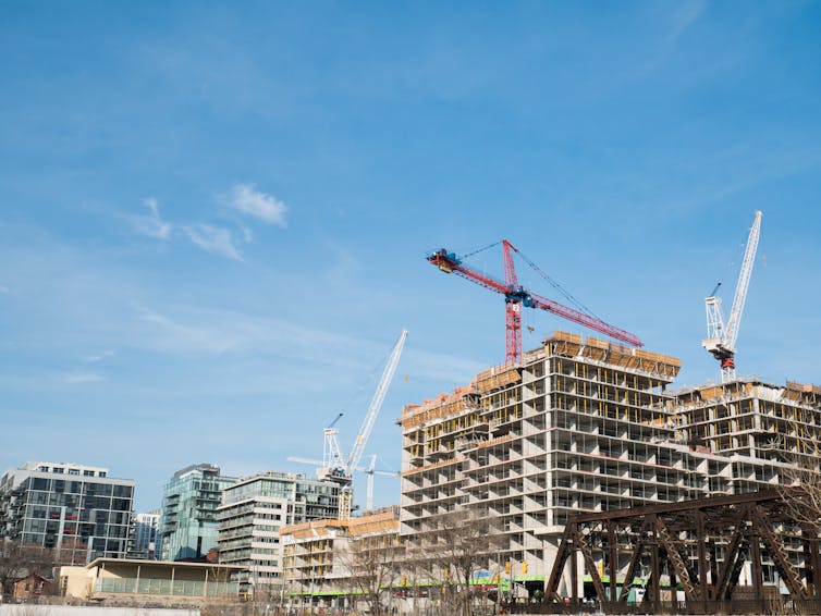 four cranes and buildings under construction