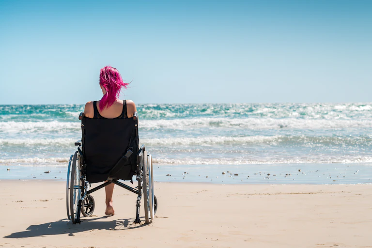 A woman on a beach in a wheelchair