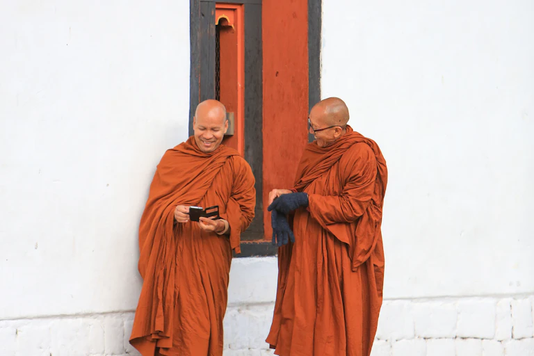 Buddhist monks checking their mobile phones