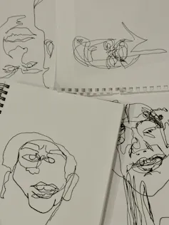 Examples from Naomi's Zouwer's family of blind contour drawings at the dinner table.