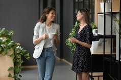 Two women chatting in the workplace