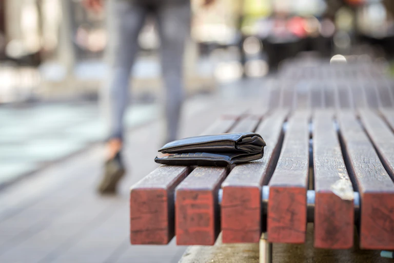 Left-behind wallet on a bench.