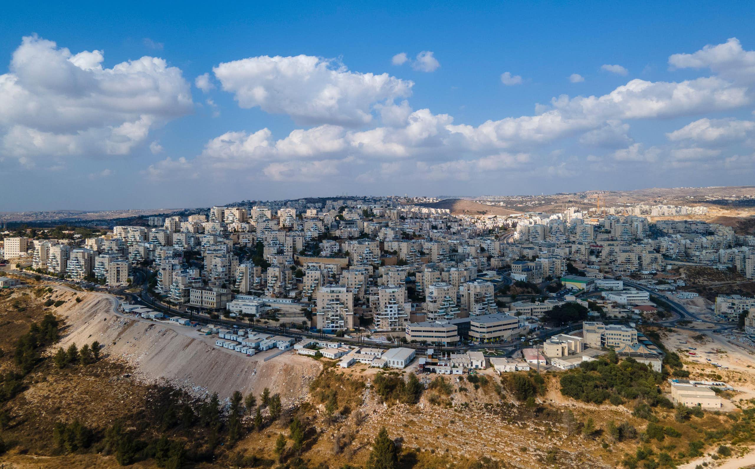 Tower blocks on a hill show the West Bank settlement of Modiin Ilit