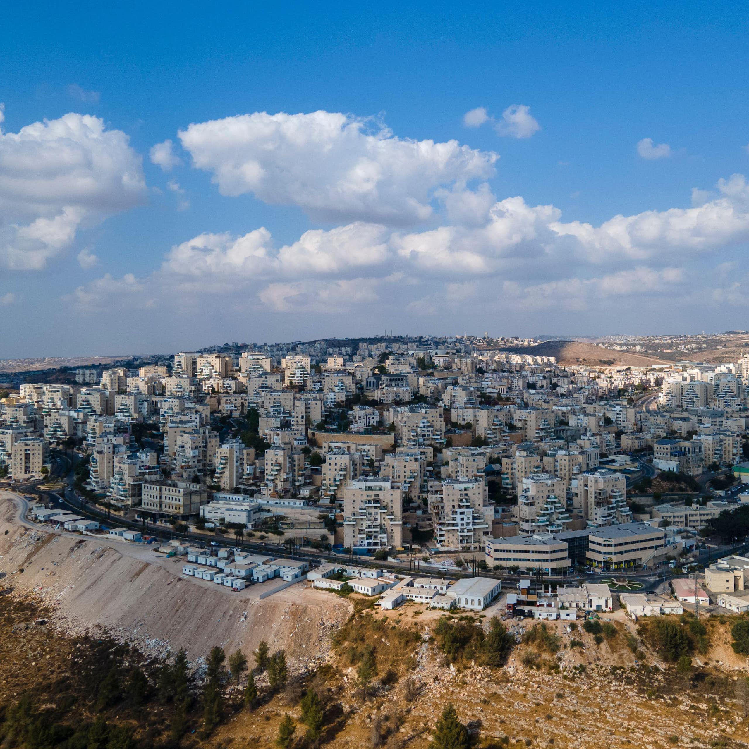 Tower blocks on a hill show the West Bank settlement of Modiin Ilit