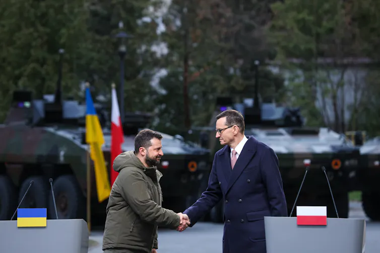 Ukrainian president Volodymyr Zelensky shakes hands with Poland's prime minister, Mateusz Morawiecki.