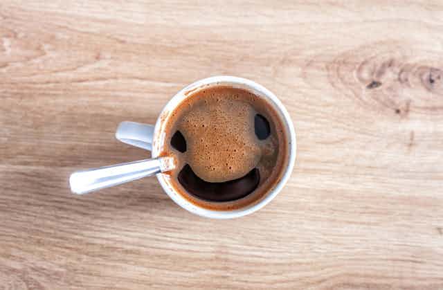 Coffee foam seems to form a smiling face