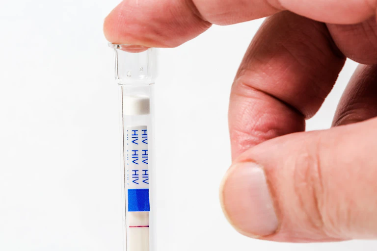 Close-up of hand holding HIV self-test