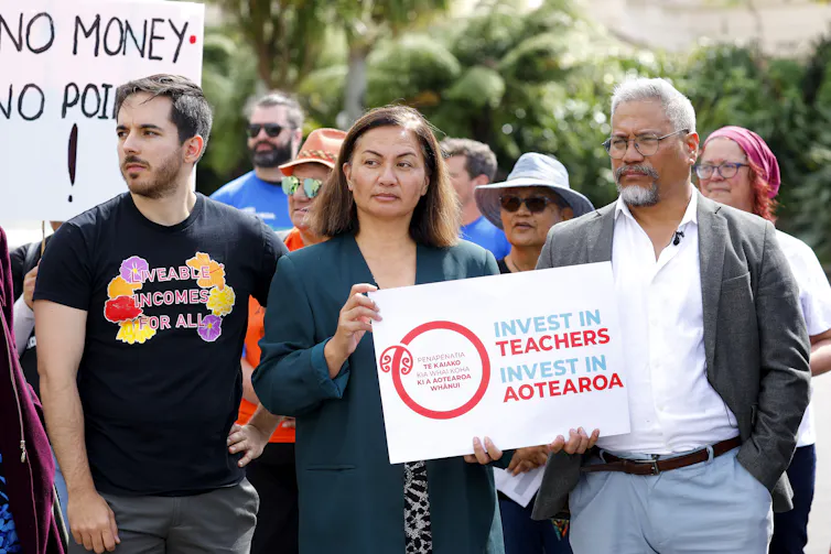 Green Party co-leader Marama Davidson holds a sign during a rally at Parliament when teachers across the country walked off the job.
