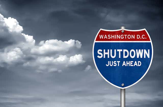 A mock road sign saying 'Washington D.C. Shutdown Just Ahead'