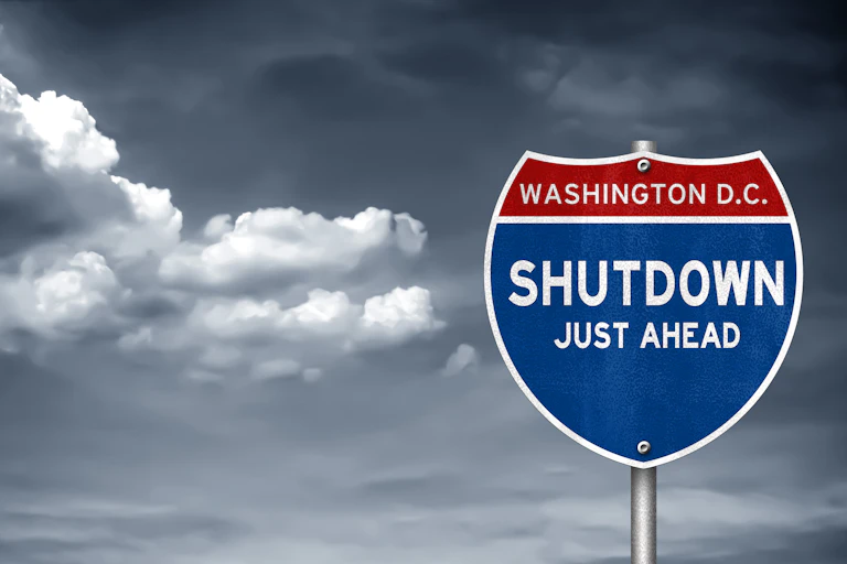 A mock road sign saying 'Washington D.C. Shutdown Just Ahead'