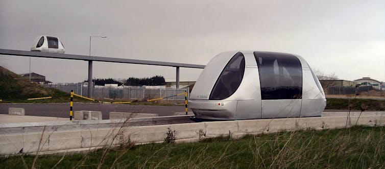 Two futuristic 'pod' carriages on specially built roadways