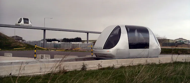 Two futuristic 'pod' carriages on specially built roadways