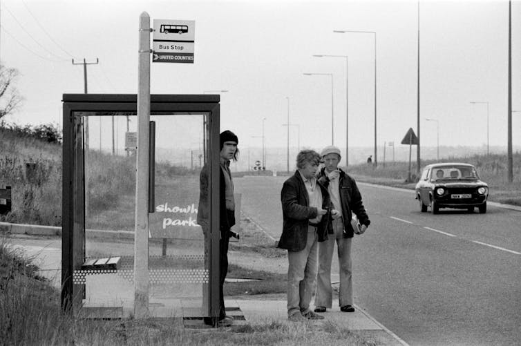 Men in the 1970s waiting at a bus stop in Milton Keynes.