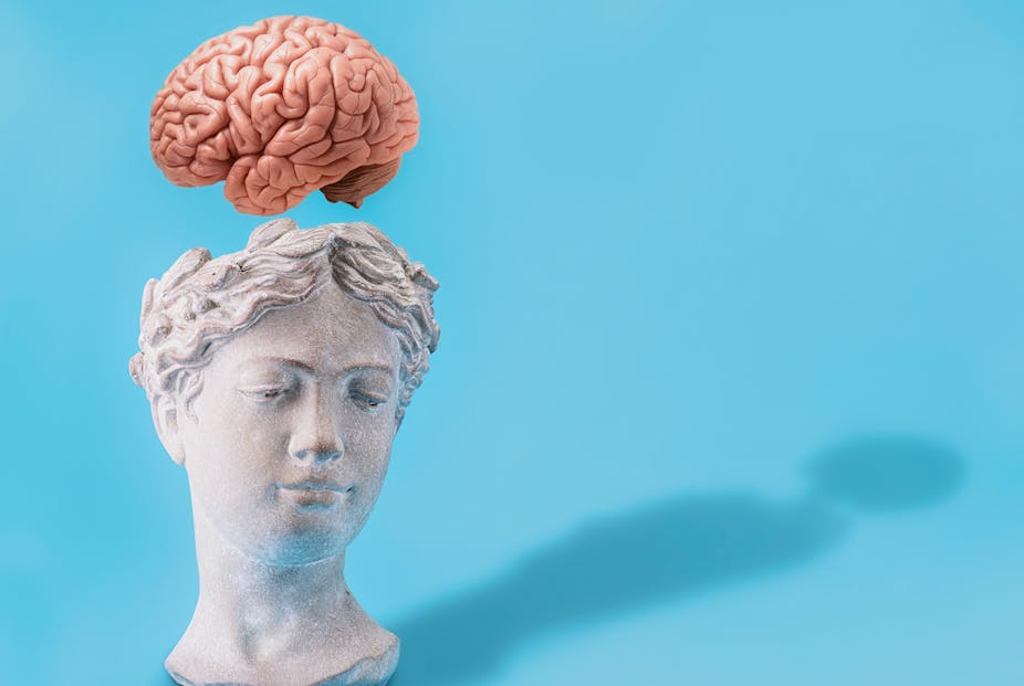 Bust of woman's head with brain floating above