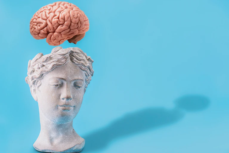 Bust of woman's head with brain floating above
